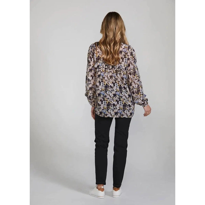 Back view blush. The Park Shirt is romantic and sophisticated. Subtle watercolour floral print. Softly gathered frill detailing at the neckline and sleeves. Size 8 - 16. 100% viscose. Hand wash.